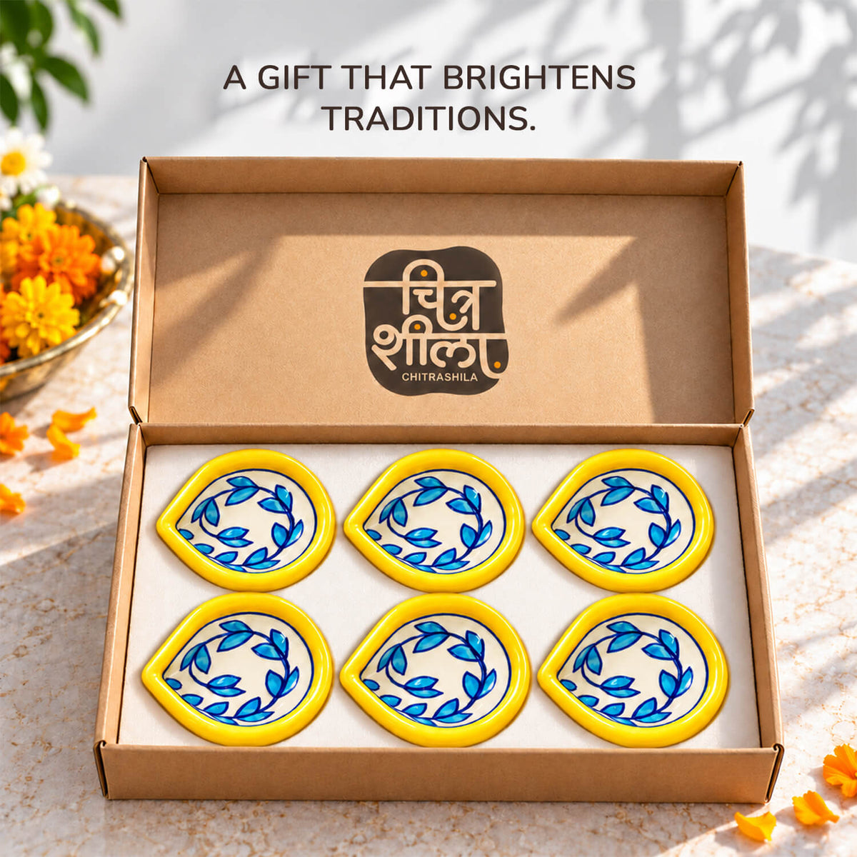 Handpainted pottery diya glowing with warm light for festive home styling